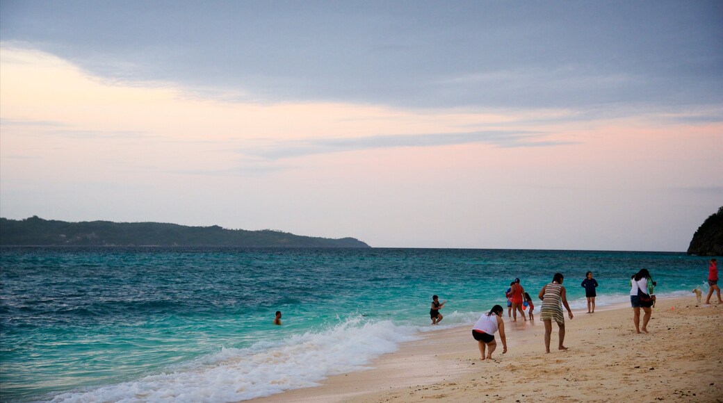 Puka Beach featuring island views, a beach and a sunset