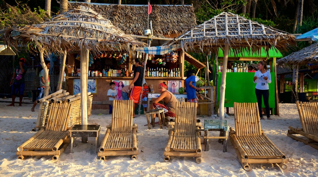 Puka Beach which includes a sandy beach and a beach bar as well as a small group of people