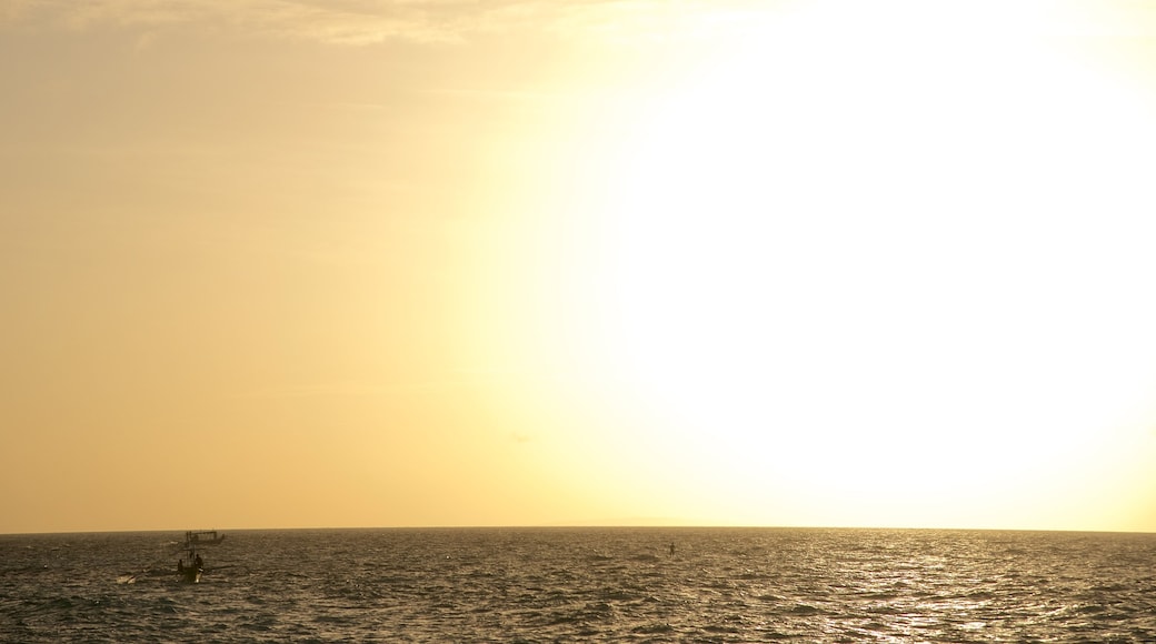 Puka Beach which includes surf, general coastal views and a sunset