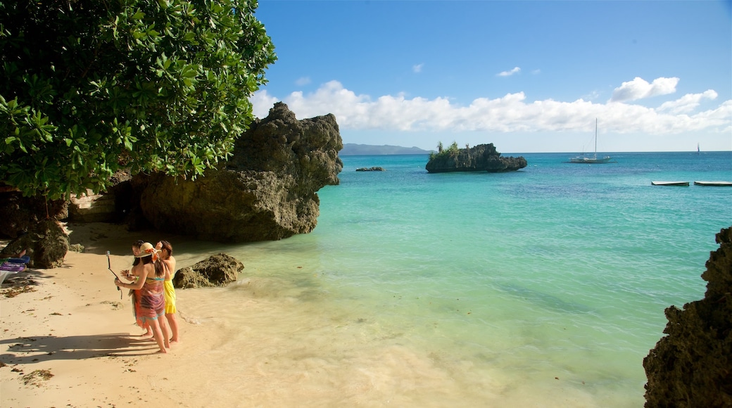 Balinghai Beach showing tropical scenes, rugged coastline and a bay or harbor