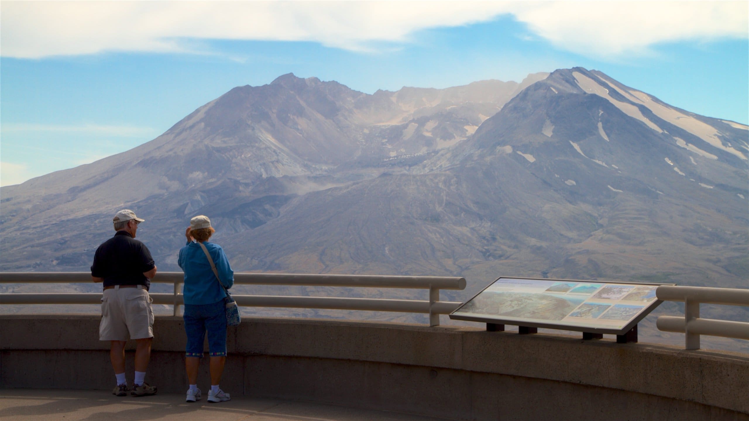 Johnston Ridge Observatory which includes signage, mountains and views