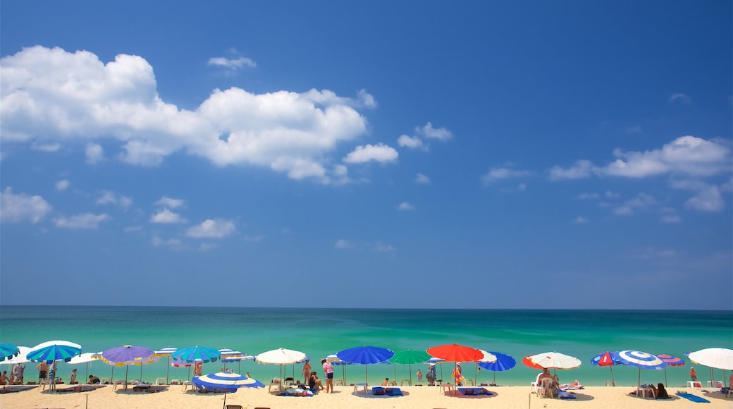 Surin showing a sandy beach and general coastal views as well as a small group of people