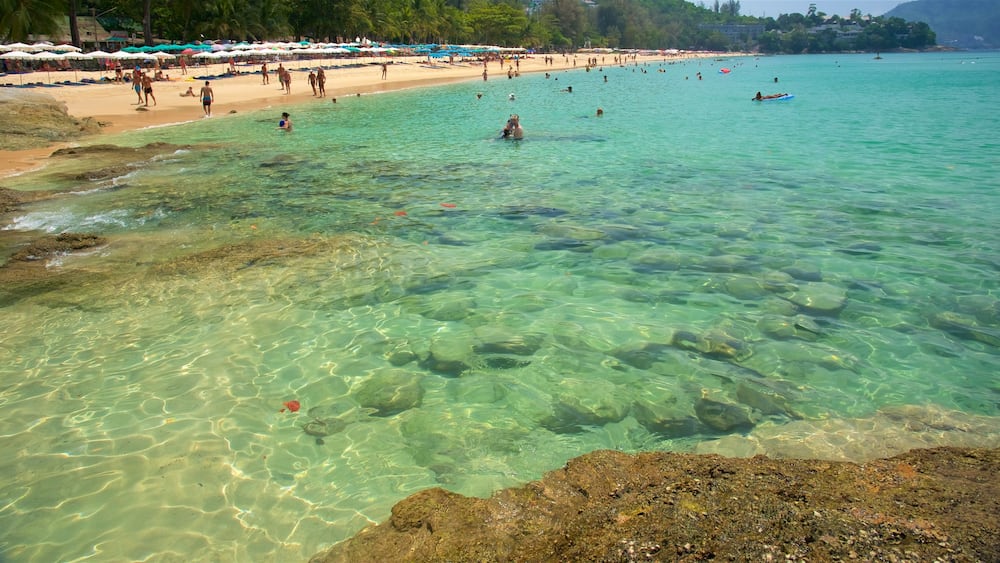 Surin Beach showing a sandy beach, rocky coastline and swimming