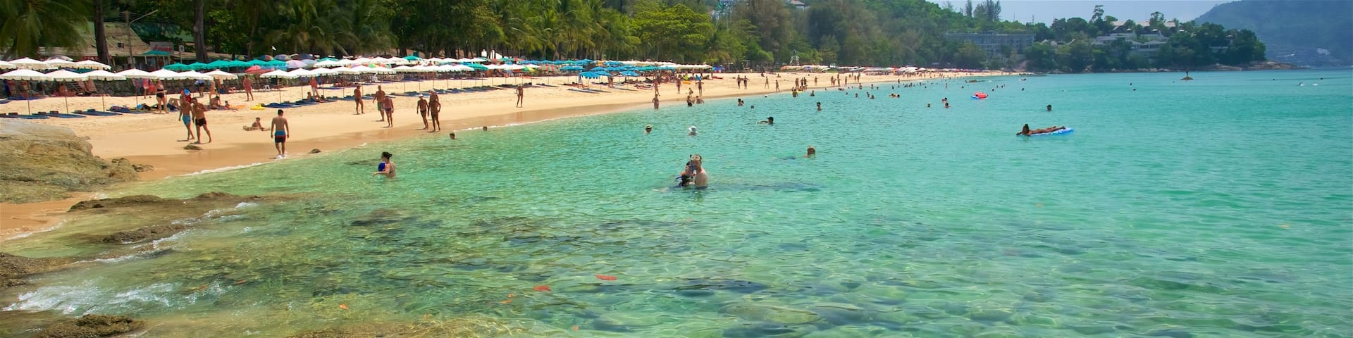 Surin Beach showing swimming, a bay or harbor and rugged coastline