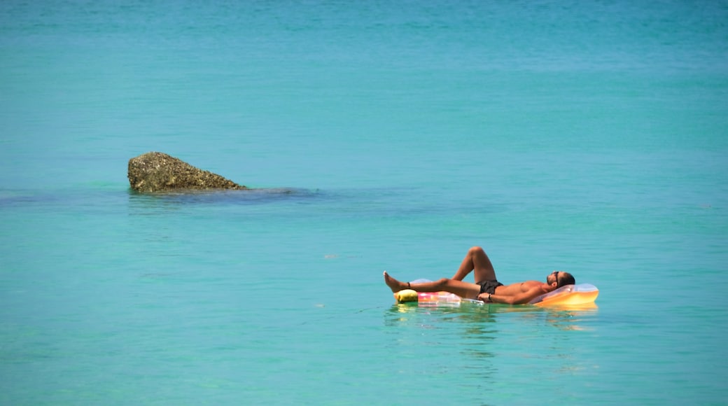 Surin Beach which includes swimming and a bay or harbour as well as an individual male