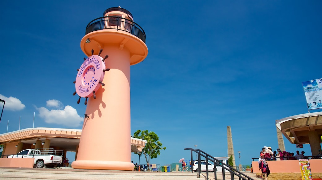 Chalong Pier featuring a lighthouse and signage