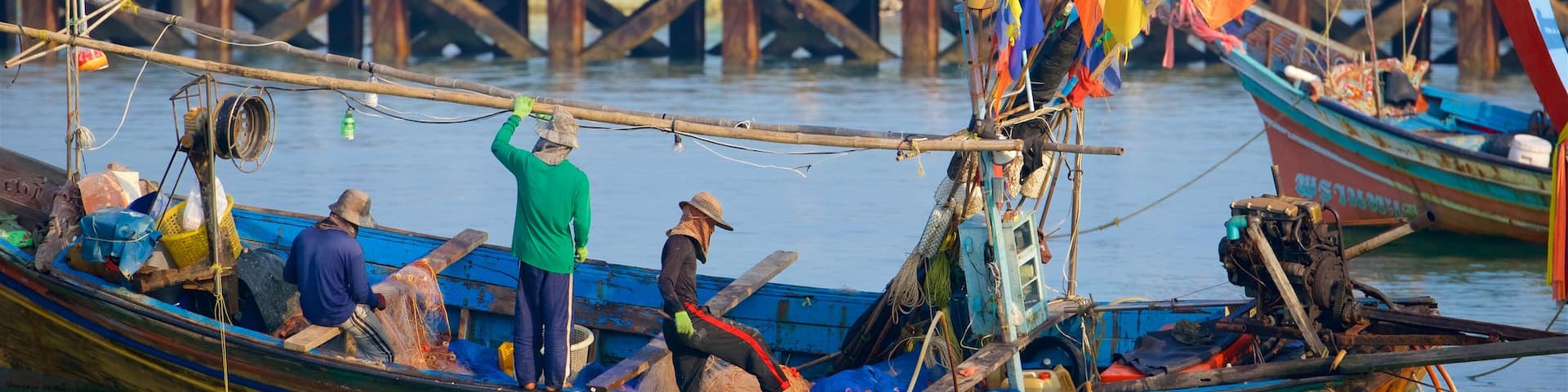 Nathon Pier showing a bay or harbor and boating as well as a small group of people