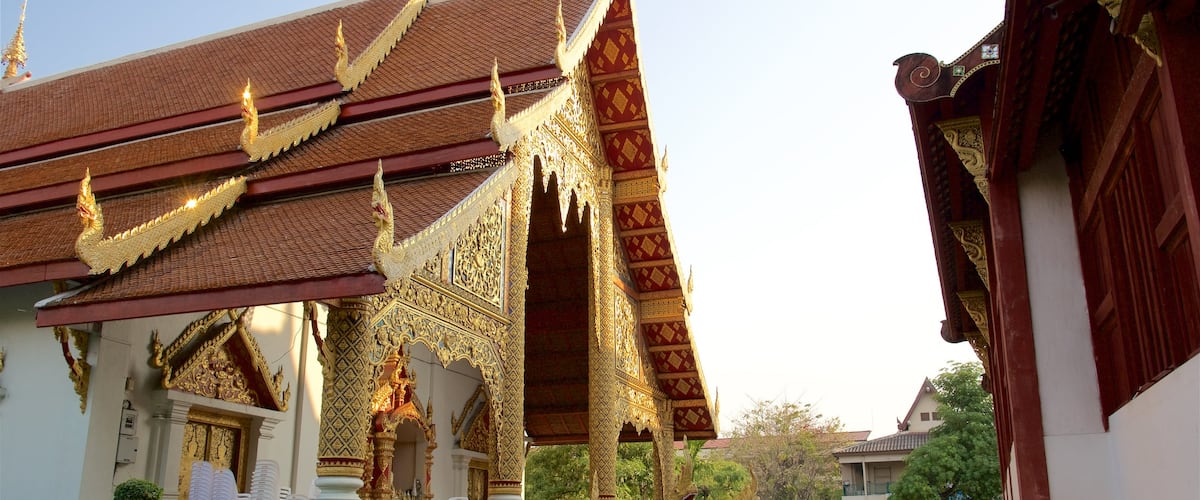 Wat Phra Singh featuring a temple or place of worship as well as a small group of people