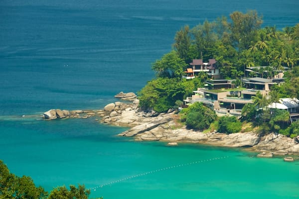 Phuket which includes rocky coastline, a coastal town and a bay or harbour