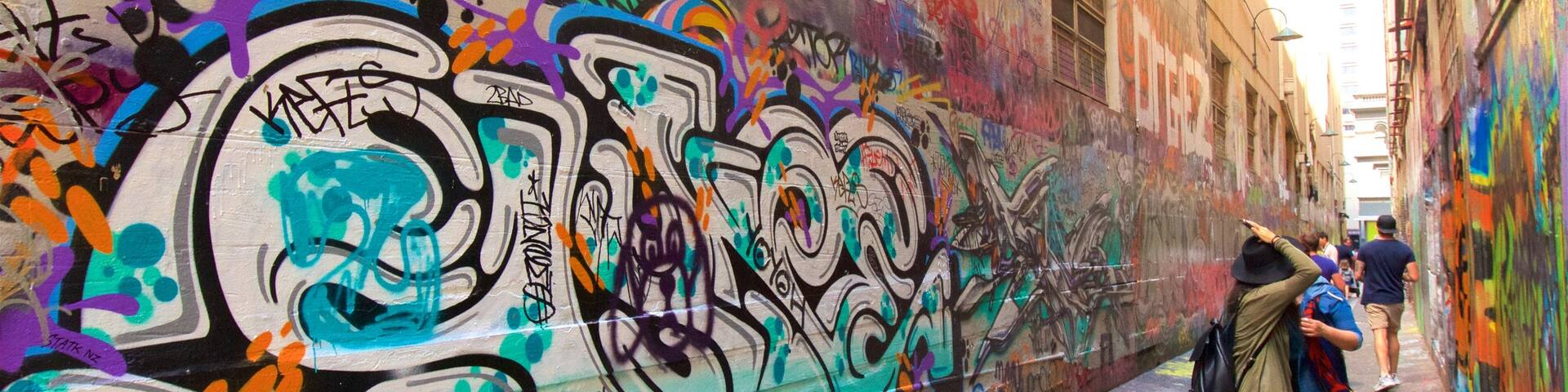 Melbourne featuring outdoor art as well as a small group of people