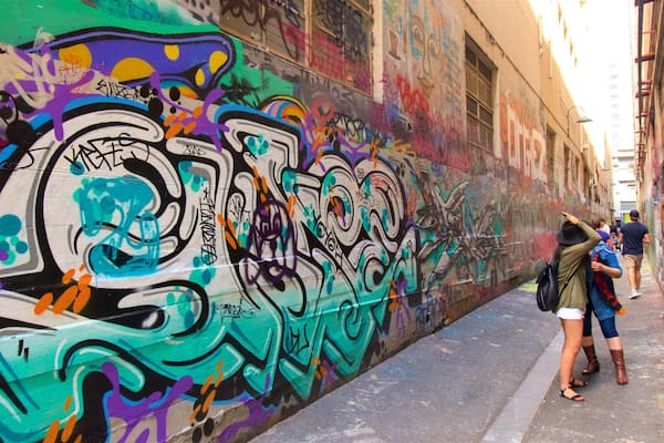 Melbourne featuring outdoor art as well as a small group of people