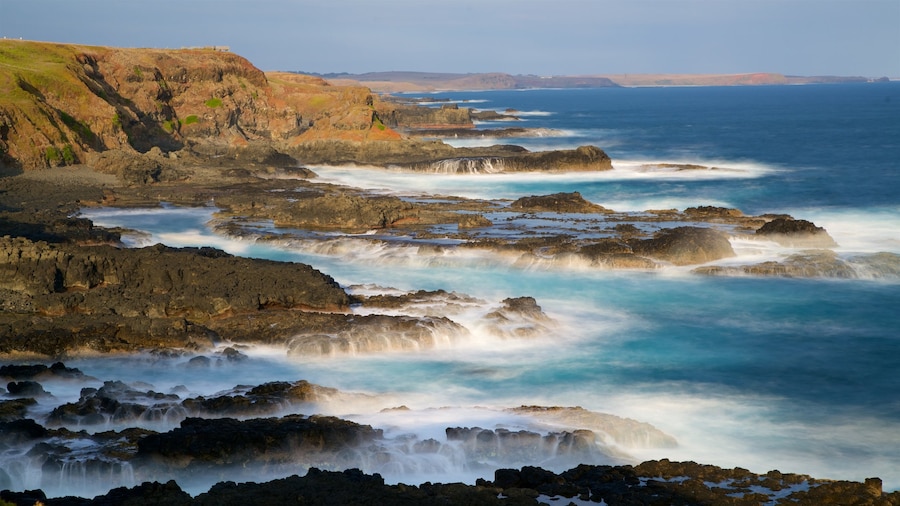 Phillip Island featuring rocky coastline, surf and a bay or harbor