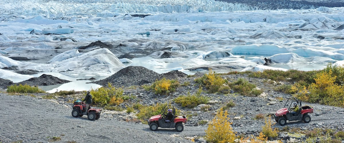 Palmer showing 4-wheel driving and mountains as well as a small group of people