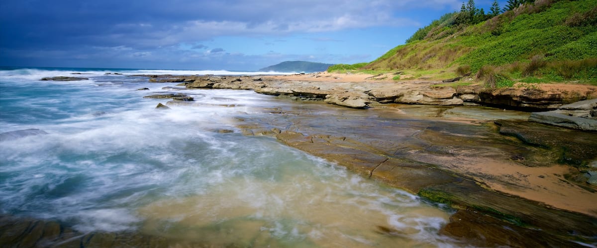 Central Coast showing rocky coastline, waves and a bay or harbor