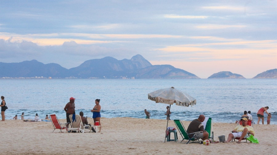 Rio de Janeiro featuring general coastal views and a sandy beach as well as a large group of people