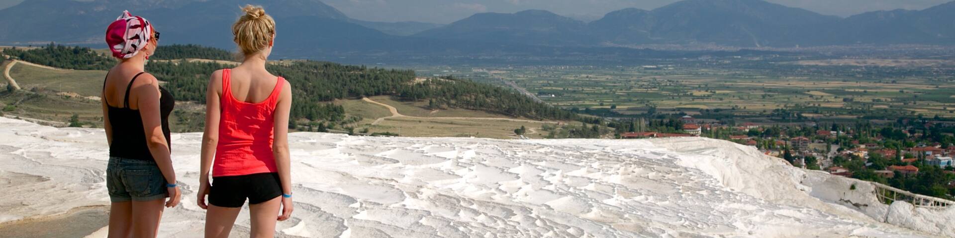 Pamukkale Thermal Pools featuring a hot spring as well as a small group of people
