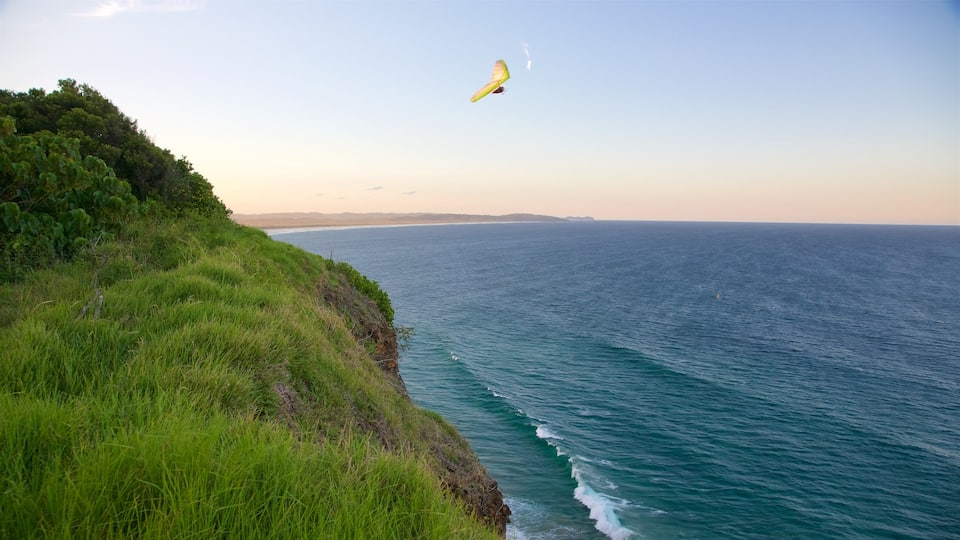 Lennox Head featuring parasailing and rugged coastline
