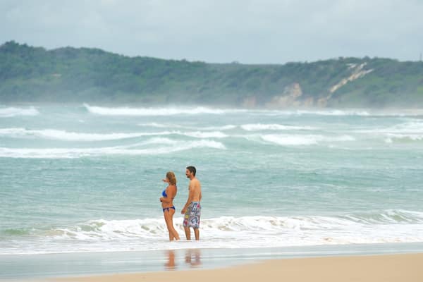 Pippi Beach featuring a sandy beach as well as a couple