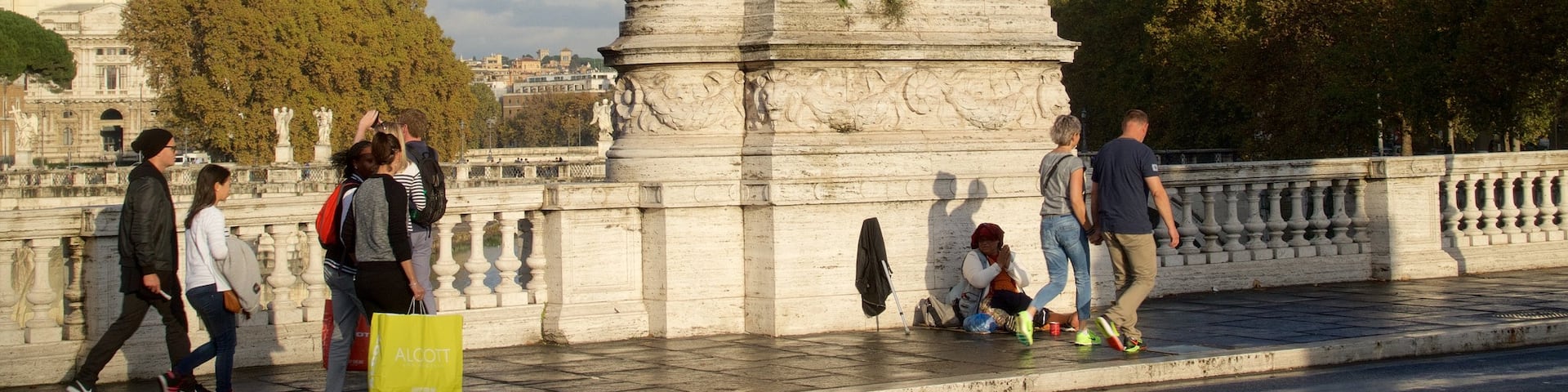 Rome featuring a bridge as well as a small group of people