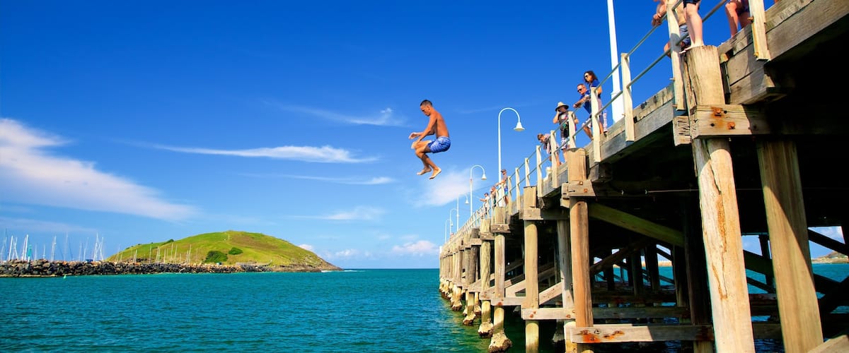 Coffs Harbour which includes a bay or harbour and swimming as well as a small group of people