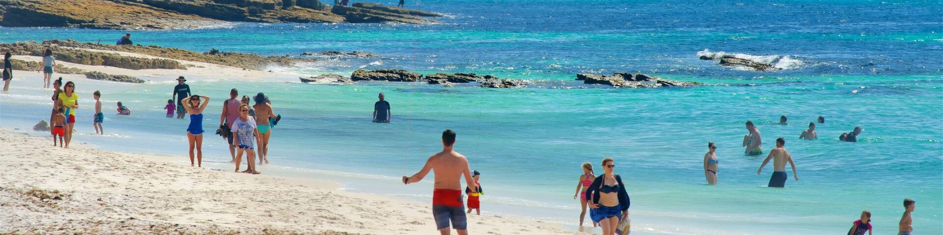 Jervis Bay National Park which includes rocky coastline and a beach as well as a large group of people