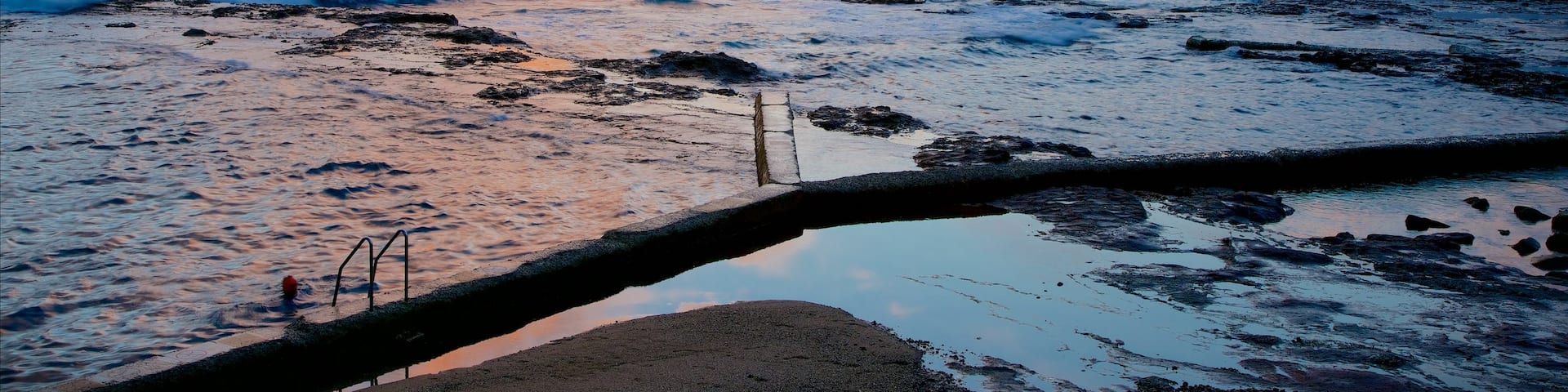 Wollongong North Beach showing a sandy beach, general coastal views and a sunset
