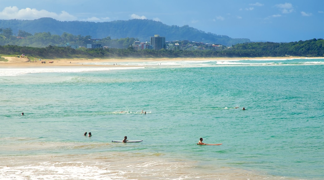 Coffs Harbour which includes a beach and swimming as well as a large group of people