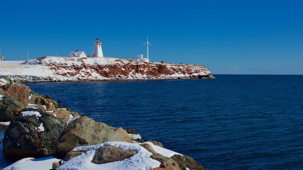 Souris Lighthouse showing a sandy beach and snow