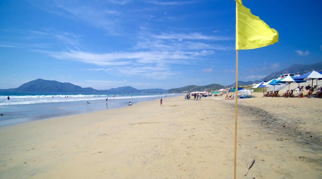 Mexico featuring a bay or harbour and a beach as well as a small group of people