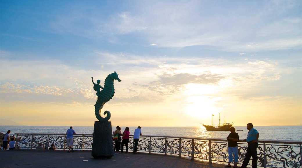 Mexico showing outdoor art, a sunset and a bay or harbor