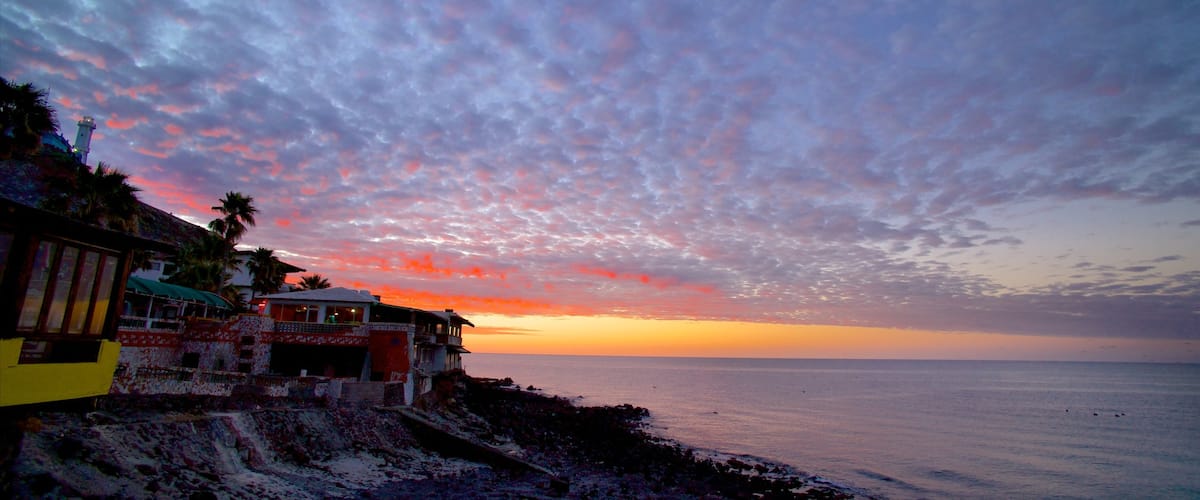 Mexico which includes a coastal town, a sunset and a bay or harbor