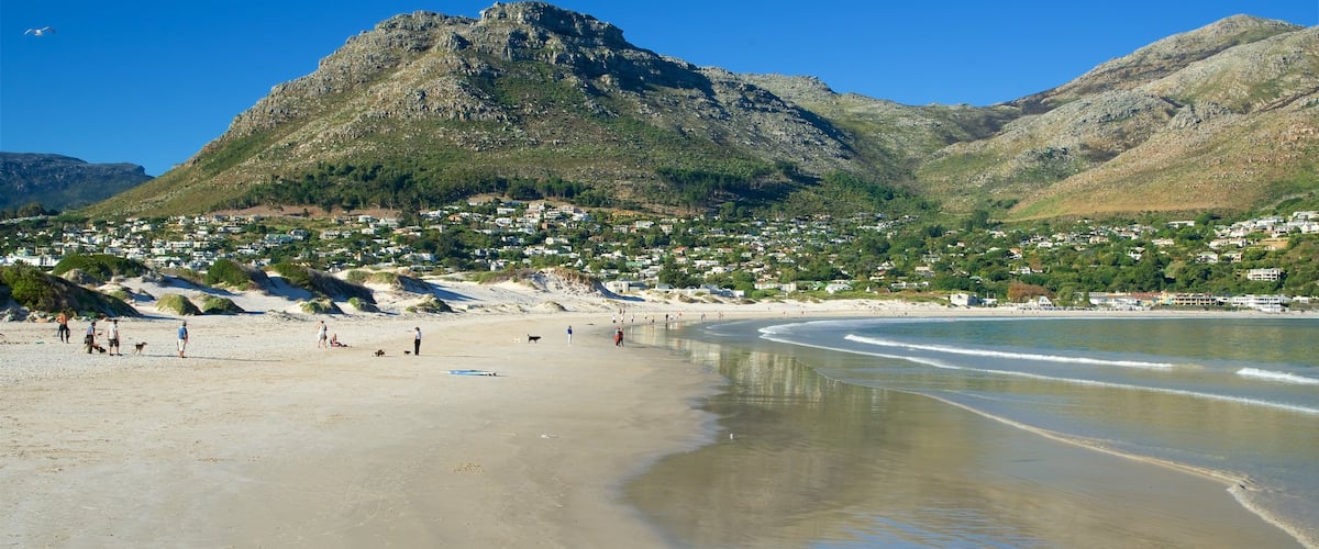 Hout Bay Beach which includes a coastal town and a sandy beach