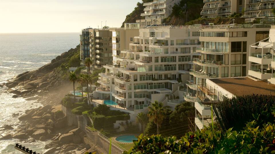 Clifton Bay Beach showing rugged coastline, a hotel and waves
