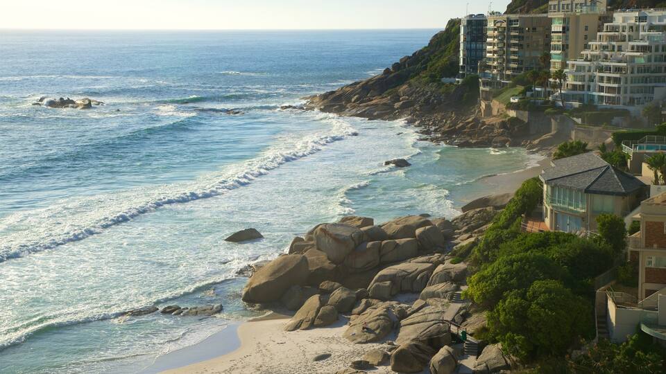 Clifton Bay Beach showing a sandy beach, rugged coastline and a coastal town