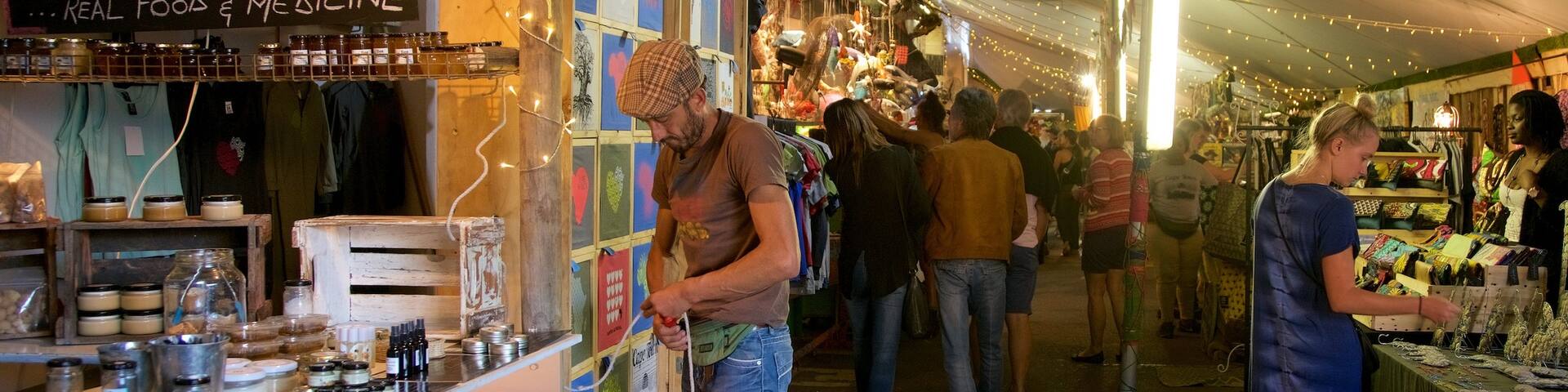 Cape Town featuring markets as well as a small group of people