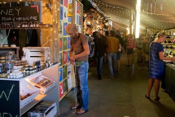 Cape Town featuring markets as well as a small group of people