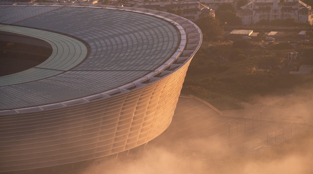 Cape Town Stadium which includes a city and a sunset