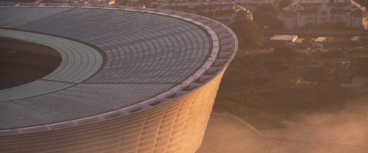 Cape Town Stadium which includes a city and a sunset