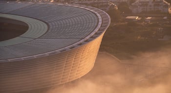 Cape Town Stadium which includes a city and a sunset