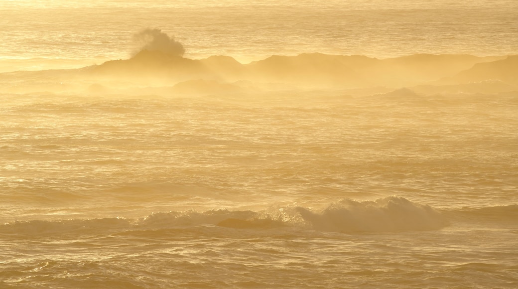 Cape Columbine Lighthouse showing a sunset and rocky coastline