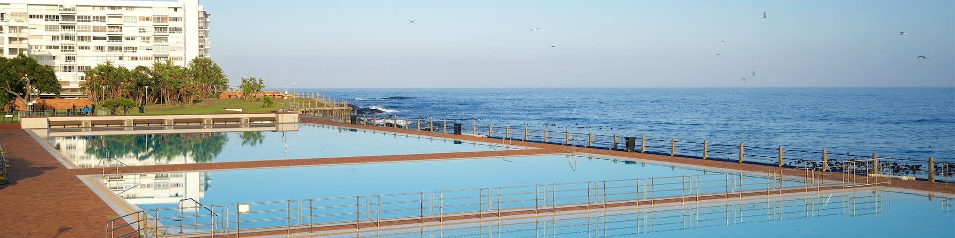 Sea Point Swimming Pool which includes general coastal views, a pool and a coastal town