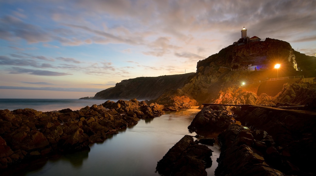 St. Blaize Lighthouse featuring rugged coastline, a sunset and a lighthouse