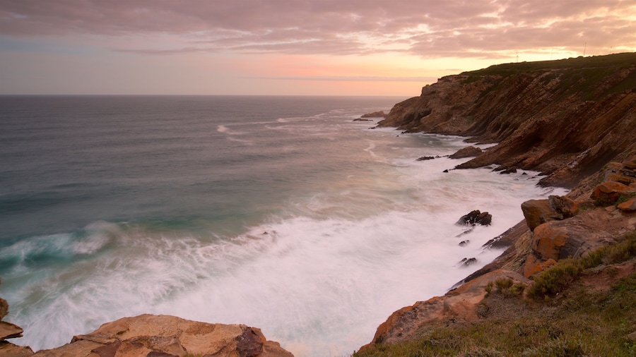 Cape St Blaize Cave featuring rocky coastline, a sunset and landscape views