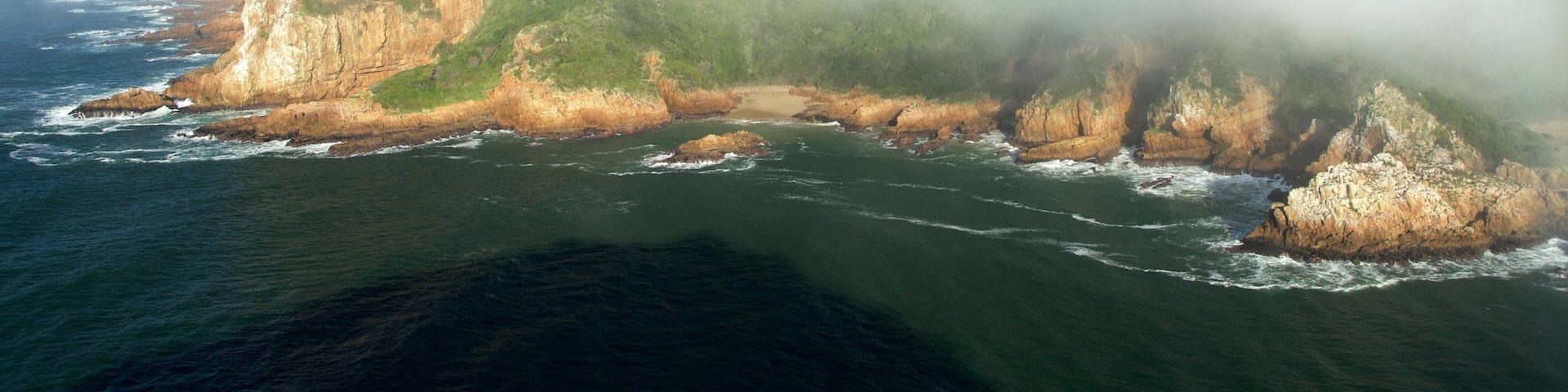 Knysna showing rugged coastline, landscape views and mist or fog