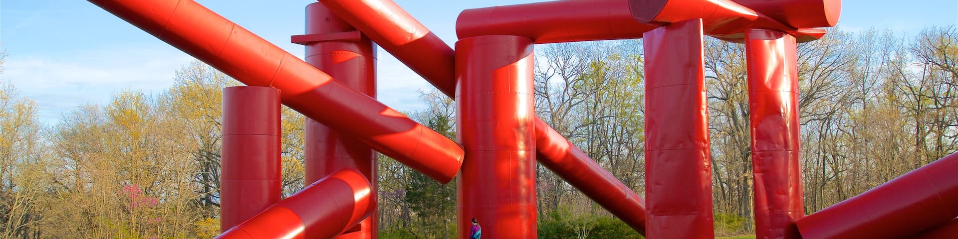 Laumeier Sculpture Park featuring a garden and outdoor art as well as an individual femail