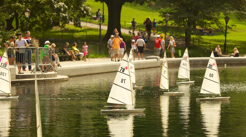 Central Park featuring a pond, sailing and a garden