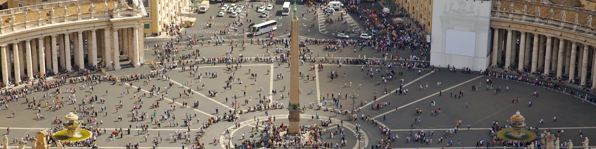 Piazza San Pietro which includes a square or plaza, a city and a statue or sculpture