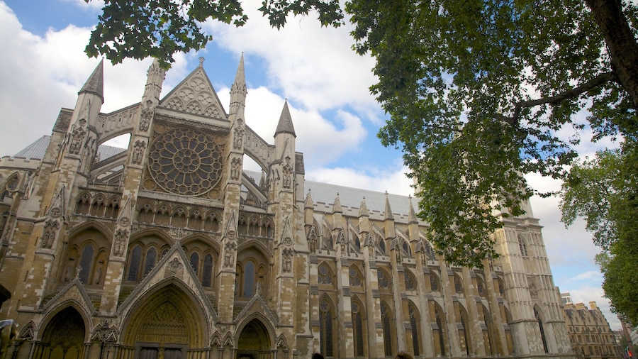 Exterior view of Westminster Abbey with Gothic architecture and lush greenery.