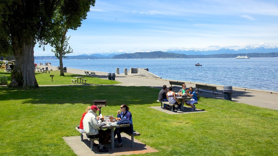 Visitors enjoying a picnic at Alki Beach with scenic views of Puget Sound in Seattle, Washington.