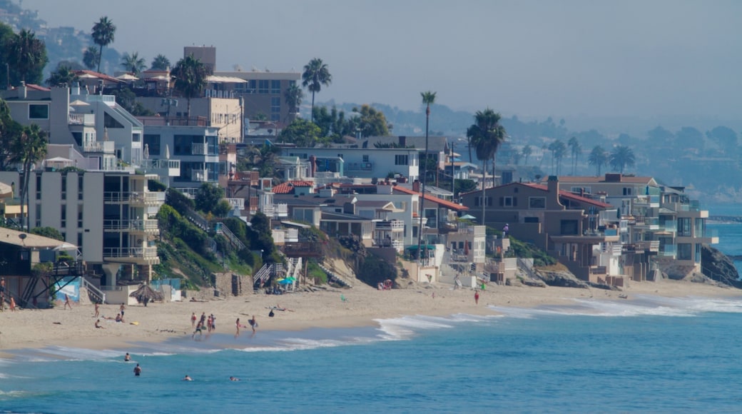 Laguna Beach showing tropical scenes, a sandy beach and swimming